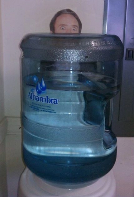 Printout of Nicholas Cage behind water cooler for prank