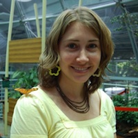 The author Robyn Norgan standing in a greenhouse