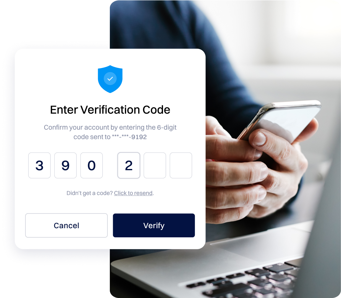 hands holding smartphone with laptop entering their 6 digit login verification code