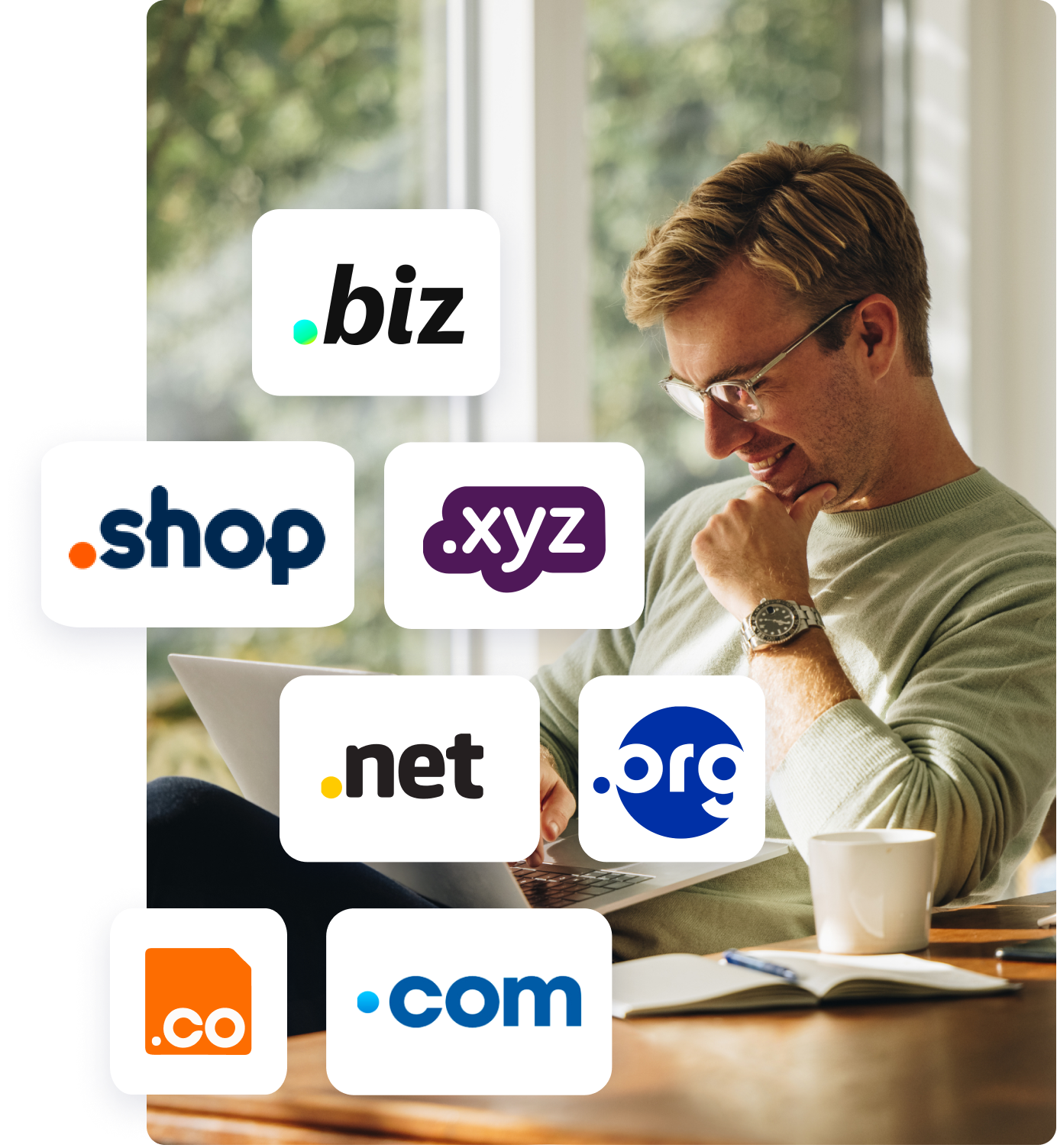 middle aged man with glasses at desk on laptop smiling with top-level domain logos floating over image